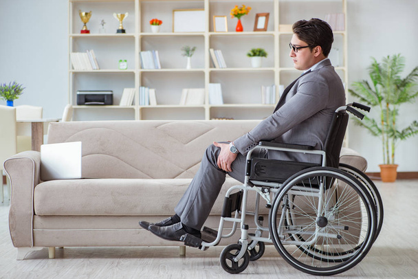 Dsabled businessman on wheelchair working home - 写真・画像