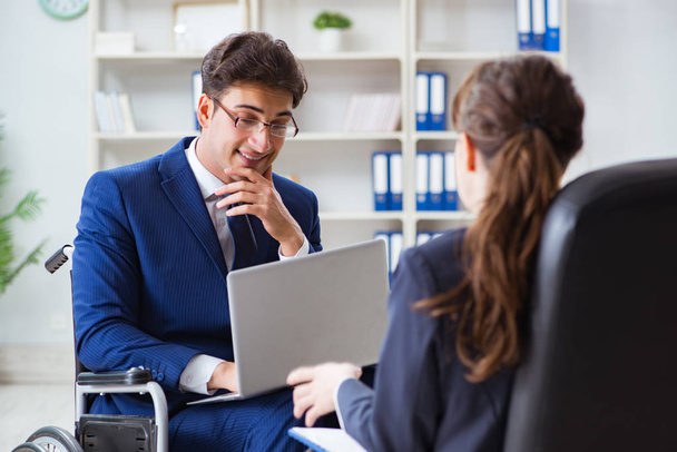 Disabled businessman having discussion with female colleague - Photo, image