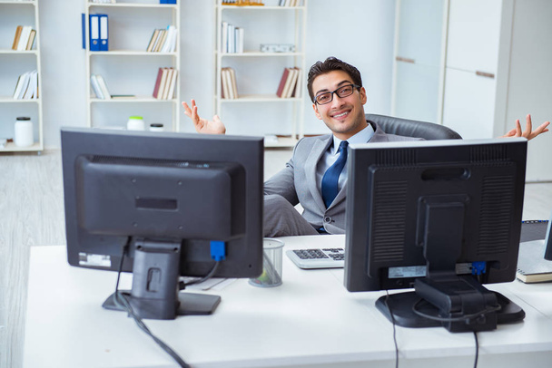 Businessman sitting in front of many screens - Photo, Image