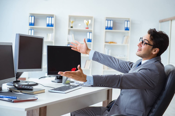 Businessman sitting in front of many screens - Foto, imagen
