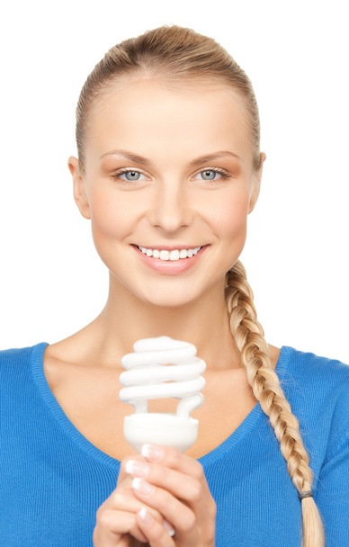 Woman with energy saving bulb - Фото, изображение