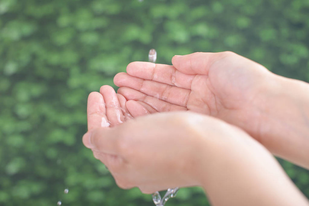Clear water pouring on hands - Photo, Image