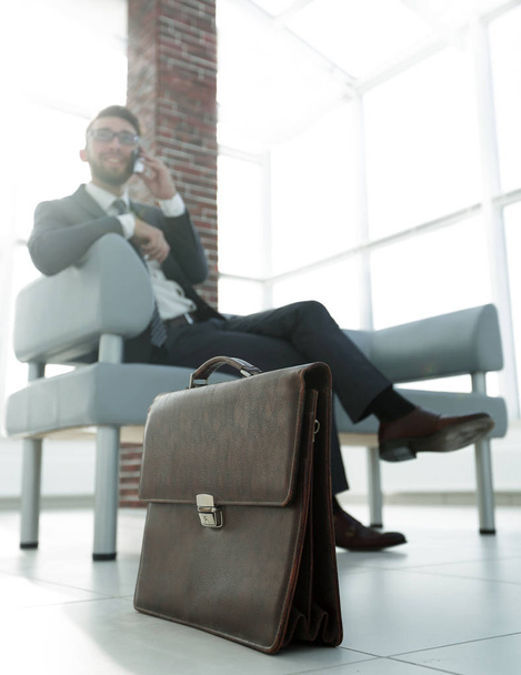 Businessman sitting on sofa in the office - Фото, изображение