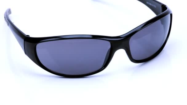 Studio close-up of a pair of sunglasses - Footage, Video