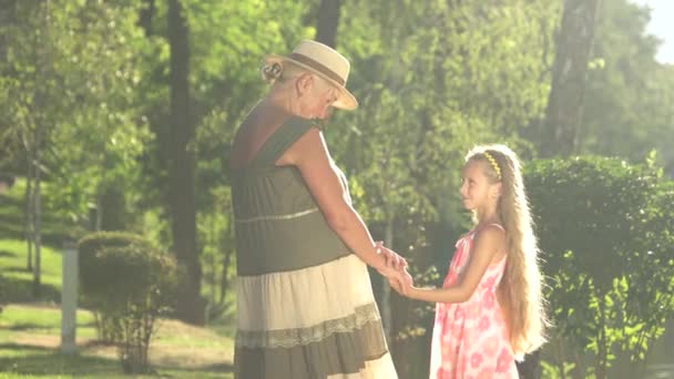 Girl with her grandmother outdoors. - Footage, Video