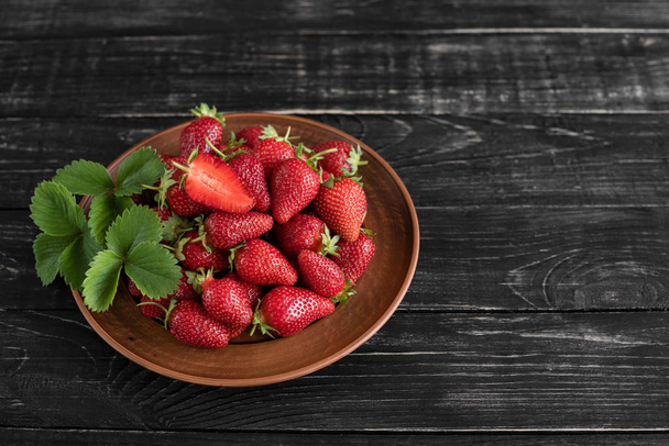 Tasty strawberry on a wooden table. It can be used as a background - Photo, Image