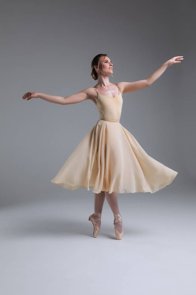 Dance is that delicacy of life! Full length side view portrait of the young attractive cheerful ballerina posing for the picture. - Foto, afbeelding