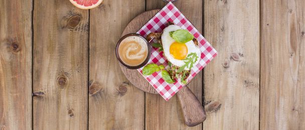 Breakfast with coffee, toasts, butter and jam on wooden background. Banner - Photo, Image