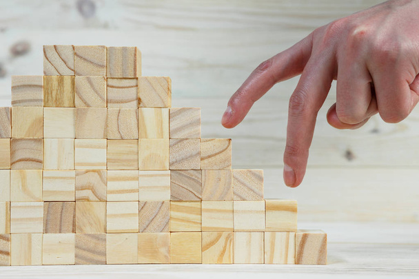 businessman making a pyramid with empty wooden cubes - Photo, Image