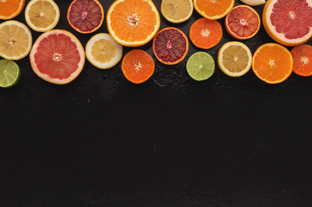 Variety of ripe citruses on black background - Φωτογραφία, εικόνα
