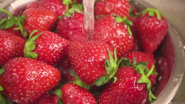 Slow motion strawberry in a metal colander under the water - Footage, Video