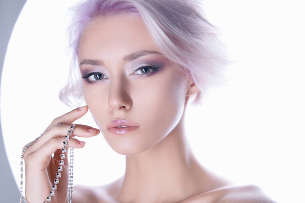 color hair young woman with jewelry.sensual blond girl with haistyle and make-up isolate fashion portrait - 写真・画像