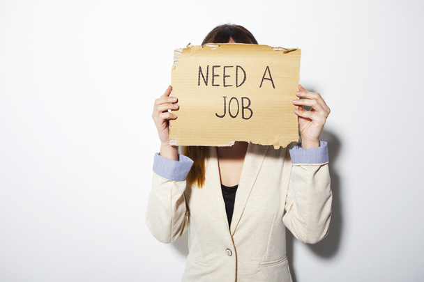 Young business woman holding a poster that says need a job - Foto, Bild