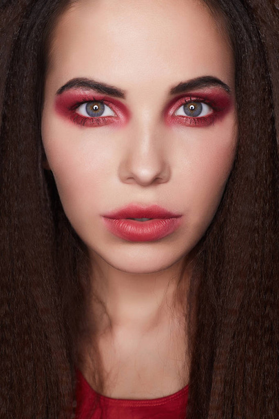 young woman make-up.beautiful girl with red eyeshadows make-up.young woman close-up portrait - 写真・画像