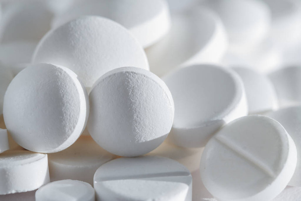 Heap of Pill tablet medicine lying isolated on white background extreme close-up macro. - Valokuva, kuva