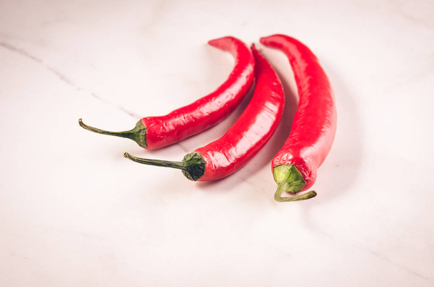red Chile on white marble table/red Chile on white marble background. selective focu - 写真・画像