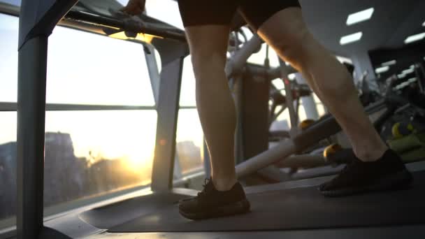 Athlete man running on treadmill in gym, warming up before workout, health - Filmmaterial, Video
