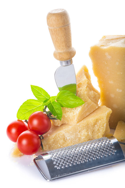Parmesan cheese or parmigiano reggiano with cherry tomatoes and basil leaves isolated on a white background - 写真・画像
