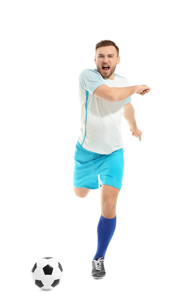 Young man playing football on white background - Photo, Image