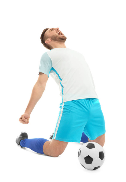 Young man playing football on white background - Zdjęcie, obraz