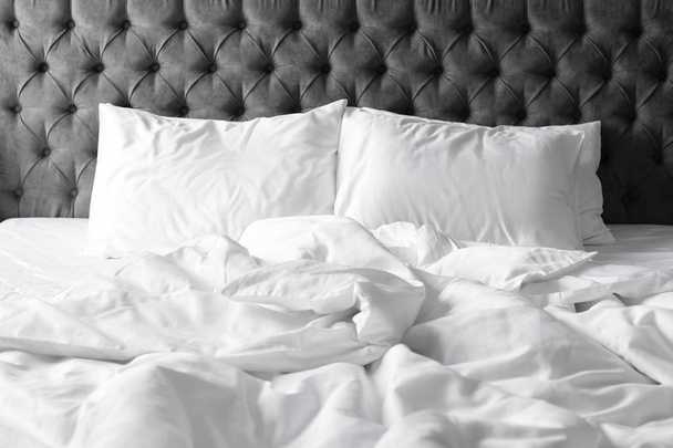 Comfortable bed with white linen and pillows at home - Foto, Imagem