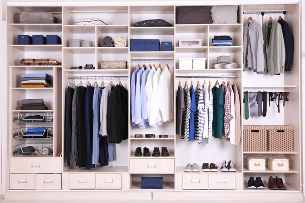 Large wardrobe with different clothes, home stuff and shoes - Foto, immagini