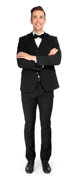 Full length portrait of handsome waiter in elegant uniform on white background - Fotó, kép