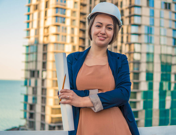 beatiful business woman engineer is standing with plan papers. - Photo, Image