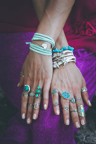 close up of young woman hands with boho accessories rings and bracelets fashion details - Photo, Image