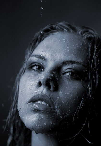 Portrait of a girl's face which water flows on a dark background - Foto, Imagen