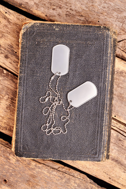 Old book and dog tags. - Photo, Image