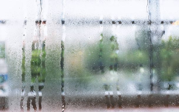 Water droplets condensation or steam background on glass after rainning in rainy day - Photo, Image
