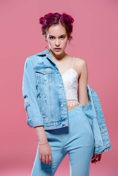 Pretty pink-haired girl in denim jacket posing on a pink background. Fashion, beauty. Youth style of clothes. - Foto, Imagen