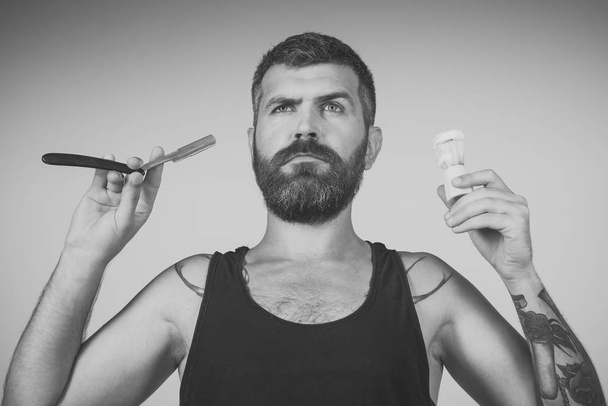 Man cut beard and mustache with razor and shaving brush. - Valokuva, kuva