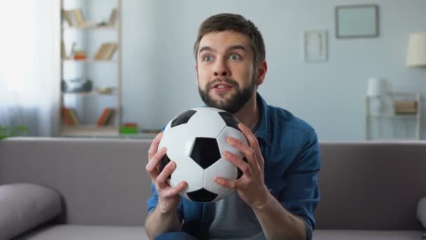 Young man nervously watching football match on tv home, frustrated at team loss - Video
