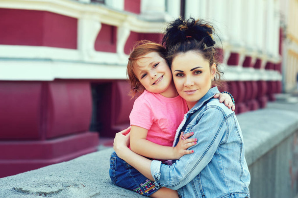 Young mother and daughter on a walk in the city - Photo, Image