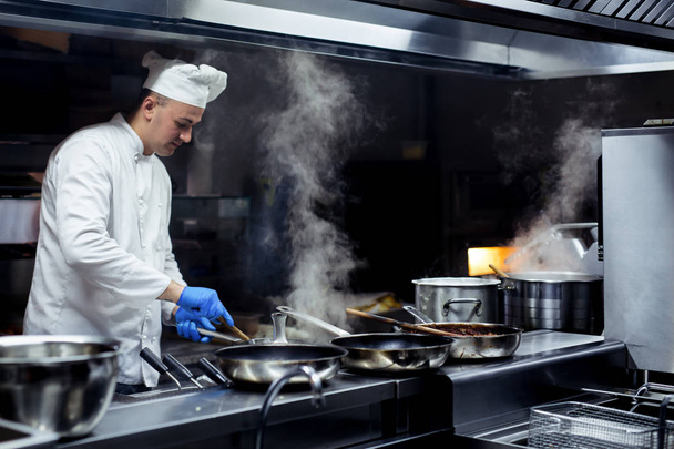 Chef working on the kitchen - Foto, imagen