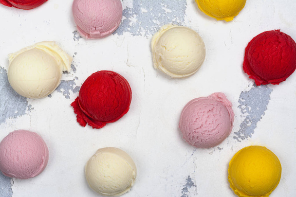 Orange, vanilla, raspberry and strawberry ice cream scoops on white background - Φωτογραφία, εικόνα
