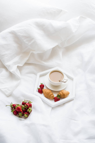 Early morning breakfast in bed, coffee and croissant with strawb - Фото, зображення