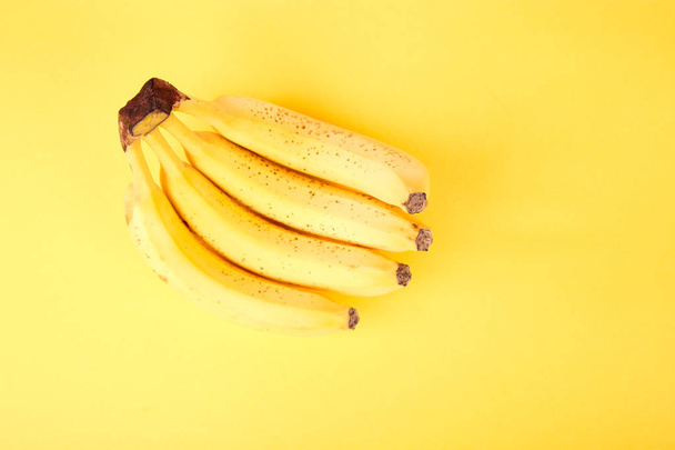 Banana on yellow paper background. Flat lay. Copy space.Minimalist. Summer Tropical - Photo, Image
