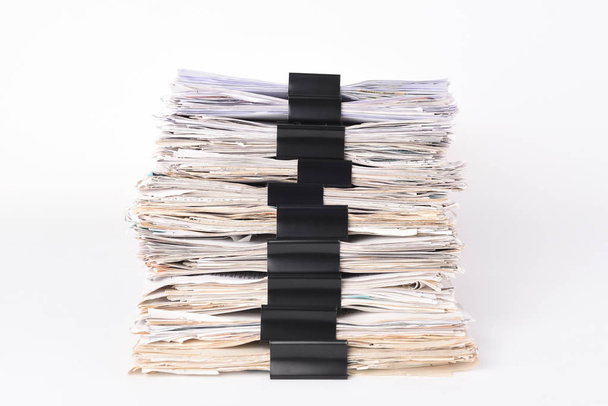 Paper stack storage and Black Paper Clip pace on white isolated background - Photo, Image