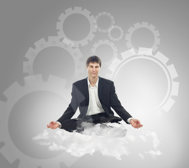 Businessman sitting in lotus position on a cloud - Photo, Image