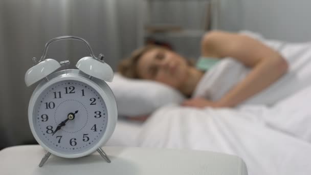 Ringing alarm clock waking up sleeping woman in bed, laziness, self-discipline - Filmagem, Vídeo