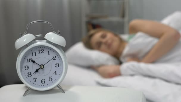 Female waking up easily to ringing alarm clock in morning, healthy lifestyle - Imágenes, Vídeo