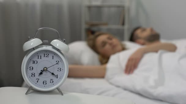 Loud alarm clock signal waking up sleeping couple in morning, sleep deprivation - Filmagem, Vídeo