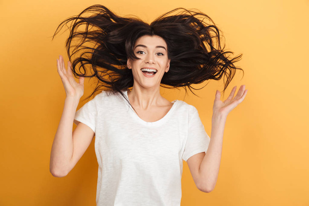 Photo of excited surprised cute lady standing isolated over yellow background looking camera. - Φωτογραφία, εικόνα