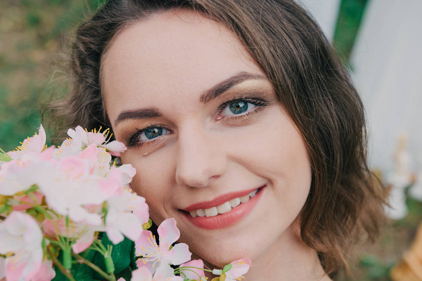 Very beautiful girl photographed in nature with fresh flowers. - Zdjęcie, obraz