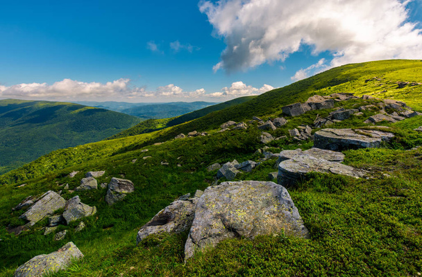 row of huge rocks on a grassy mountain. lovely summer scenery of Carpathian mountains. cloud approaching from behind the hill - Photo, image
