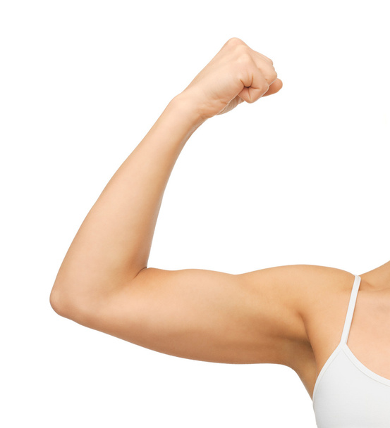 Sporty woman flexing her biceps - 写真・画像