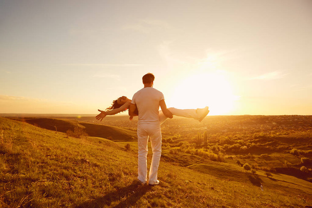 Happy couple on a beautiful sunset in nature - 写真・画像